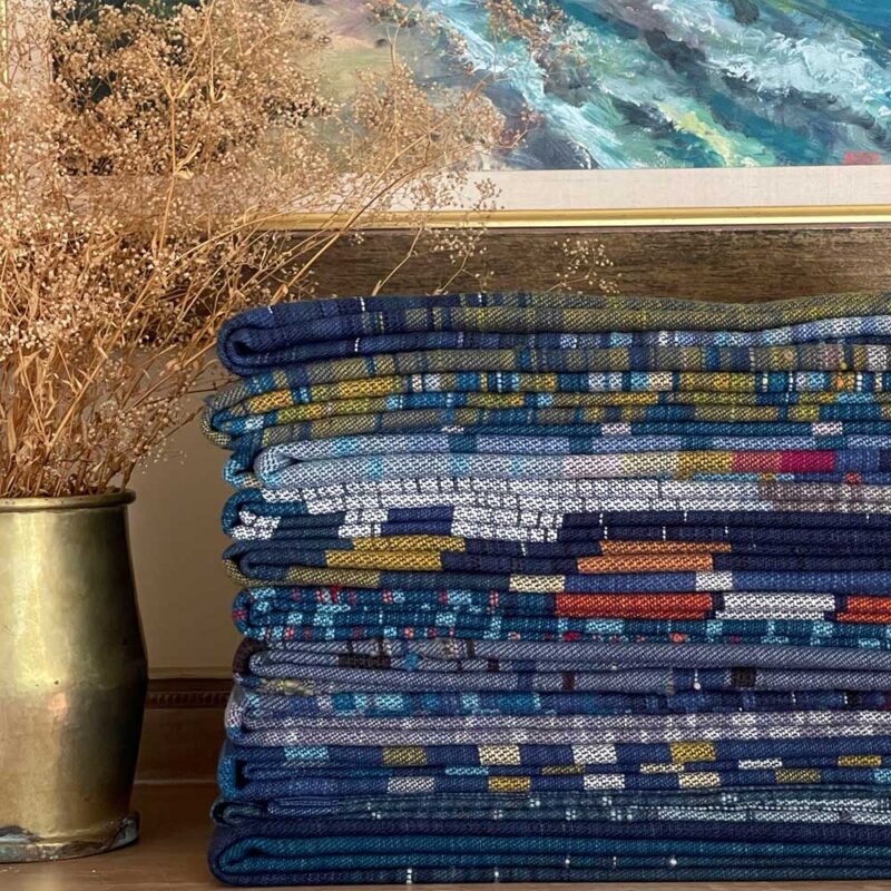 Swans Island Co. Ocean Limited Edition Throws - A stack of 11 unique handwoven throws.