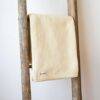 Swans Island Company's Belgrade Borders Throw is made in Maine with soft lofty cotton.. Extra soft and cuddly throw is shown here in Straw color.
