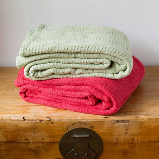 Swans Island Company's Caroline Blanket. Soft 100% Cotton blanket with bands of woven texture. Made in USA with 100% American cotton. Shown here in Sage and Candy Apple Red.