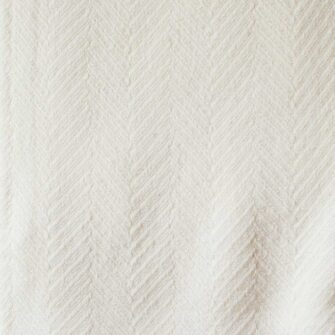 Swans Island Company's Chevron Chenille Blanket. Soft 90% Cotton 10% rayon blanket with a large woven herringbone texture. Made in USA with undyed natural colored yarn. Shown here in Natural, swatch.
