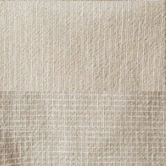 Swans Island Company's Pinstripe Linen Blanket. Made in USA, has an allover subtle pinstripe design highlighted with a checked border. Linen Cotton blend. Shown here in Linen color. Swatch, checked border.