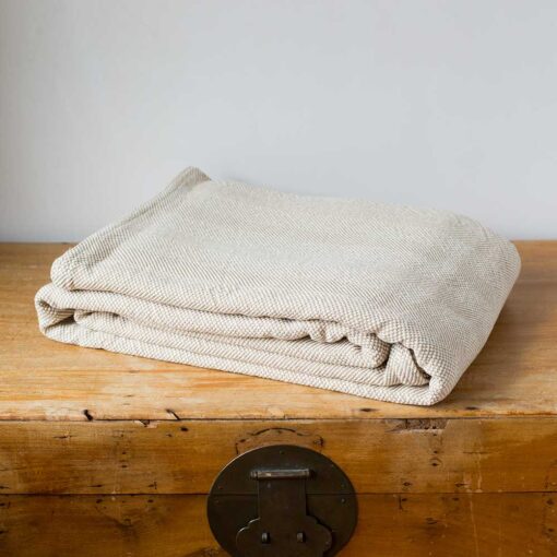 Swans Island Company's Savannah Blanket. Soft 100% Cotton blanket with woven herringbone texture. Made in USA with 100% American cotton. Shown here in Tan.
