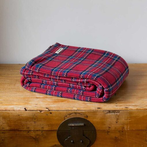 Swans Island Company's Traditional Plaid Blanket. Soft 100% Cotton blanket with a dyed-in-the-yarn classic tartan plaid pattern. Made in USA with 100% American cotton. Shown here in Red.