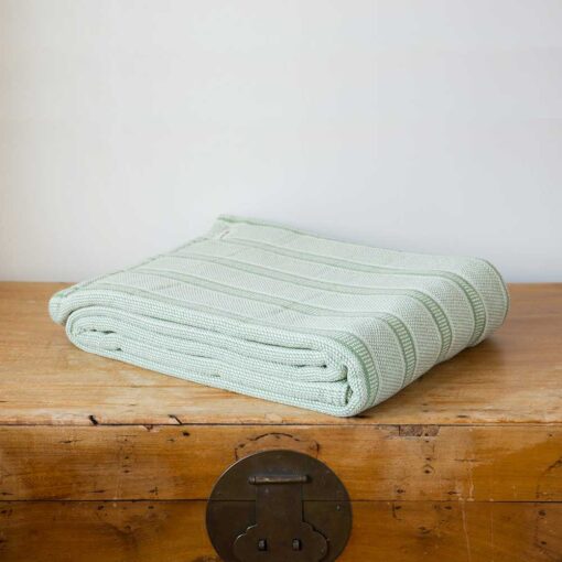 Swans Island Company's Cotton Tulare Blanket. Soft 100% Cotton blanket with yarn-dyed woven stripes. Made in USA with 100% American cotton. Shown here in Sage.