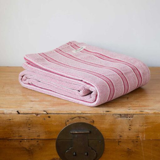 Swans Island Company's Cotton Tulare Blanket. Soft 100% Cotton blanket with yarn-dyed woven stripes. Made in USA with 100% American cotton. Shown here in Rose.