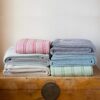 Swans Island Company's Cotton Tulare Blanket. Soft 100% Cotton blanket with yarn-dyed woven stripes. Made in USA with 100% American cotton. Shown here in multiple colorways.