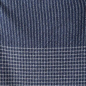 Swans Island Company's Pinstripe Linen Throw. Made in USA, has an allover subtle pinstripe design highlighted with a checked border. Linen Cotton blend. Shown here in Marled Navy. Swatch