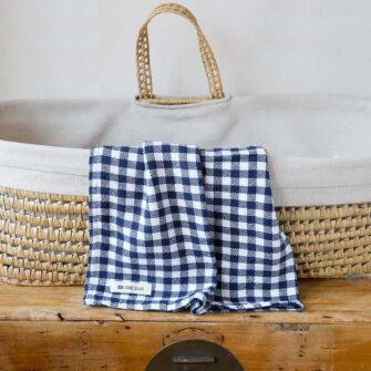 Swans Island Company's Gingham Check Baby Blankets. Woven in Maine with soft American cotton yarns in an assortment of colors. Shown here in Navy and white.