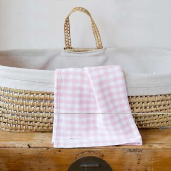 Swans Island Company's Gingham Check Baby Blankets. Woven in Maine with soft American cotton yarns in an assortment of colors. Shown here in Pink and white.