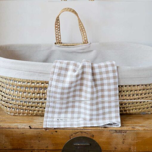 Swans Island Company's Gingham Check Baby Blankets. Woven in Maine with soft American cotton yarns in an assortment of colors. Shown here in Light Brown and White.