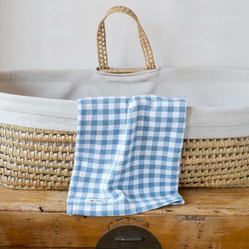 Swans Island Company's Gingham Check Baby Blankets. Woven in Maine with soft American cotton yarns in an assortment of colors. Shown here in Wedgwood and White.
