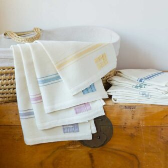 Swans Island Company's classic Grace Baby Blankets. Handwoven in Maine with soft organic merino wool yarns. Pure undyed organic merino wool with an assortment of rich hand-dyed stripe colors. Each blanket comes in a beautiful presentation gift box, perfect for gifting.