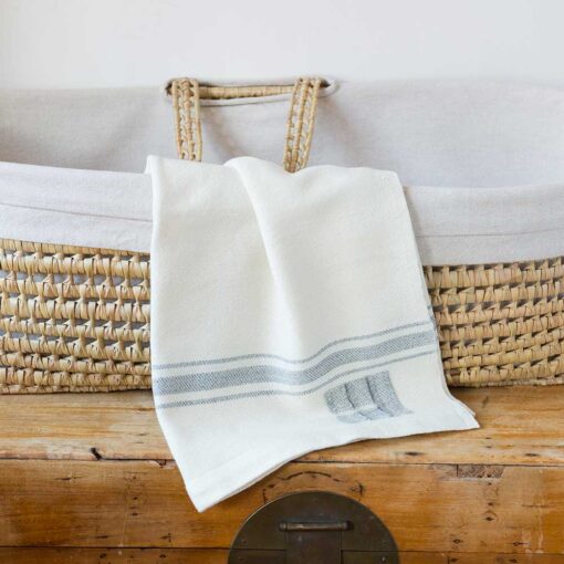 Swans Island Company's classic Grace Baby Blankets. Handwoven in Maine with soft organic merino wool yarns. Pure undyed organic merino wool with an assortment of rich hand-dyed stripe colors. Each blanket comes in a beautiful presentation gift box, perfect for gifting. Shown here in White with Grey stripes.