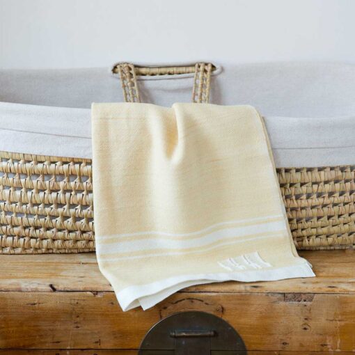 Swans Island Company's Modern Grace Baby Blankets. Handwoven in Maine with soft organic merino wool yarns in an assortment of rich hand-dyed colors. Each blanket comes in a beautiful presentation gift box, perfect for gifting. Shown here in Honey with natural stripes.