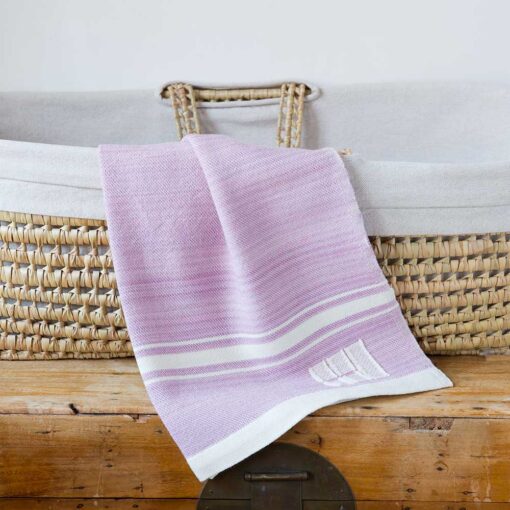 Swans Island Company's Modern Grace Baby Blankets. Handwoven in Maine with soft organic merino wool yarns in an assortment of rich hand-dyed colors. Each blanket comes in a beautiful presentation gift box, perfect for gifting. Shown here in Rose Quartz with natural stripes.
