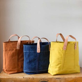 Swans Island Company's Small East West Tote in heavy cotton canvas - by Immodest Cotton. Mustard Seed, Dark Indigo, Chartreuse.