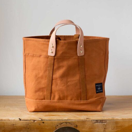 Swans Island Company's Small East West Tote in heavy cotton canvas - by Immodest Cotton. Caramel, Dark Indigo, Mustard Seed.